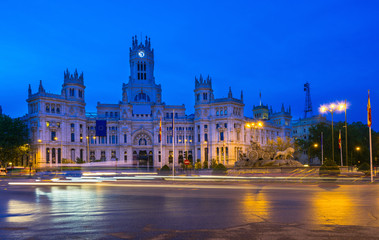 Fototapeta na wymiar Night view of Cybele's Square (Plaza de la Cibeles) and Central Post Office (Palacio de Comunicaciones) in Madrid, Spain