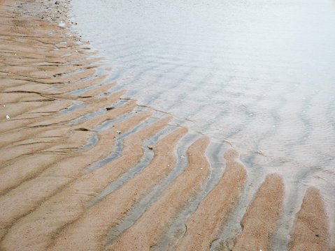 wave and wind create texture of sand sea