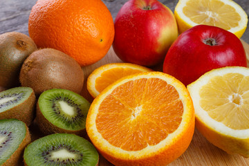 Naklejka na ściany i meble Fresh fruits oranges, kiwi, lemons, apples arranged in a group, natural still life for healthy food.