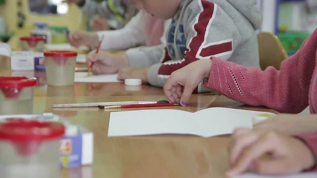 children draw kindergarten pencils and paints on paper