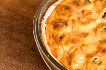 Part of cake with cottage cheese and prunes in plate.