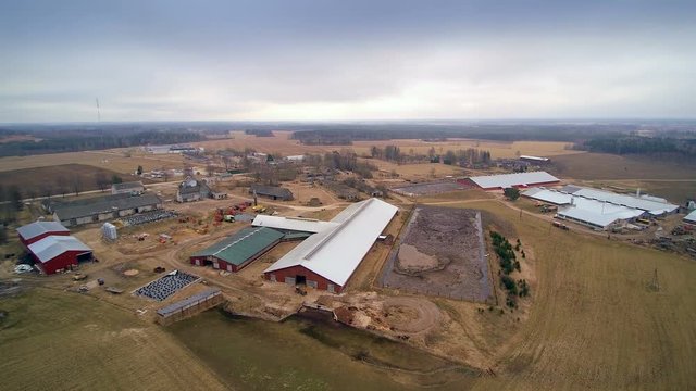 Aerial shot of the big farm in the country shown the roof of the animal houses in the farm