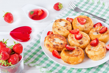Delicious Cottage cheese pancakes with raisins and strawberries