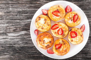 Delicious Cottage cheese pancakes with raisins and strawberries