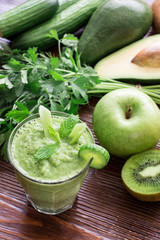 Green vegetable smoothie and ingredients.