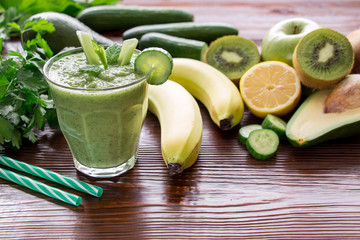 Green vegetable smoothie and ingredients.