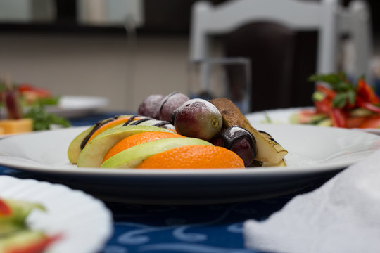 Variety of delicious dishes on plates on blue tablecloth at restaurant