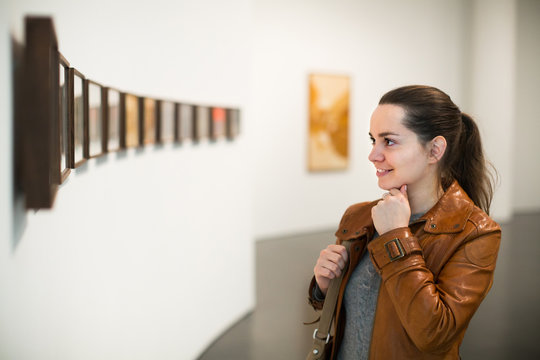 Young woman at gallery exhibition