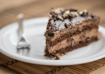 Slice of chocolate cake  garnished with nuts