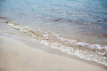 Fototapeta na wymiar Waves. Sand. Sea. Outdoor recreation concept. Summer background.