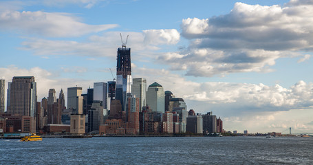 Low Angle Architectural View of Modern Glass Skyscrapers Featuring One World Trade Center Building Against Blue Sky, Manhattan