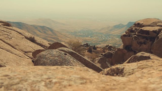 Amazing aerial view of desert and mountains covered with fog or mist on a cloudy day. 