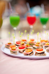 Colourful cocktails and snacks on the table near the pool