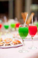 Colourful cocktails and snacks on the table near the pool