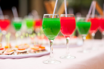 Colourful cocktails and snacks on the table near the pool