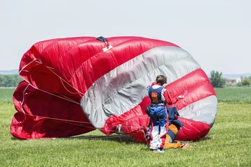Tuinposter Parachutist after landing. © murmakova