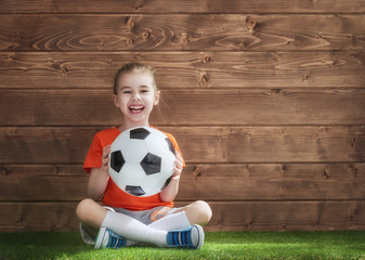 Girl plays football.