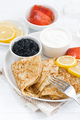 crepes with salted fish, sour cream and caviar, vertical