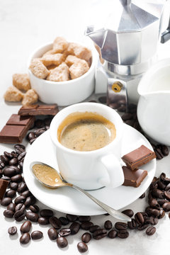 cup of espresso, coffee beans and sweets, vertical