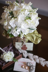 wedding bouquet of white small flowers lily-of-the-valley at girl's hand