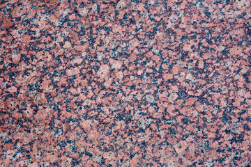 Stone Background of mottled red granite igneous rock