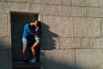 Fototapeta premium guys kissing standing in the window opening