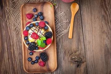Foto op Plexiglas Tasty ice cream dessert with fruit in a waffle bowl. © Arkadiusz Fajer