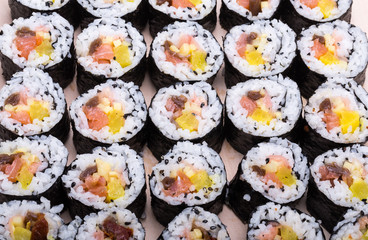  sushi fresh maki rolls isolated on wooden board