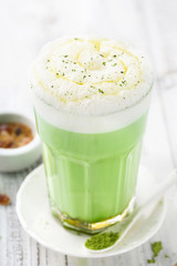Matcha latte on wooden background