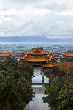 The Three Pagodas of Chongsheng Temple near Dali Old Town, Yunnan province, China. Scenic mountains are visible in background. Ancient pagodas are a popular tourist destination of Asia.