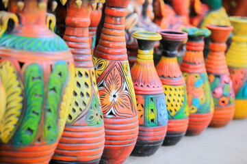 Colorful handcrafted pots in a row