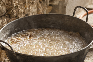 traditional home production of sausages on the island of Mallorca, Spain. Boiling parts of pork for sausage filling