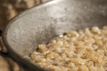 traditional home production of sausages on the island of Mallorca, Spain. Boiling fat parts of pork.