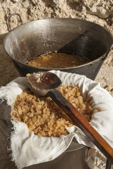 traditional home production of sausages on the island of Mallorca, Spain. Boiling fat parts of pork.