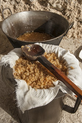 traditional home production of sausages on the island of Mallorca, Spain. Boiling fat parts of pork.