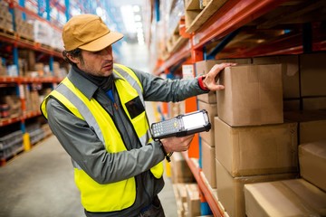 Warehouse worker using hand scanner