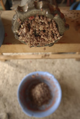 traditional home production of sausages on the island of Mallorca, Spain, milling the meat for sausages
