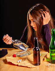 Girl in depression drinking alcohol and smokes cigarettes in solitude. Alcohol problems.
