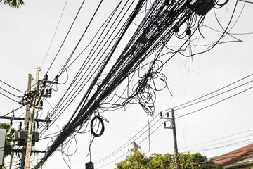 Messy electrical cables in thailand - Uncovered optical fiber technology open air outdoors asian...