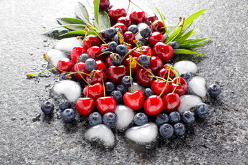 mixed Berries on Marble table and ice cubes in the shape of Hear