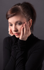 Young Woman With Hands on Face