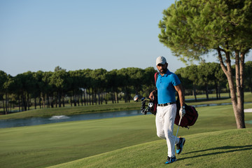 Fototapeta premium golf player walking and carrying bag