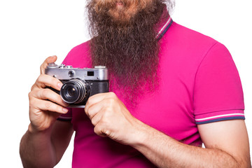 The portrait of bald bearded man photographer with pink t shirt holding classic camera. isolated on white background. studio shot. 