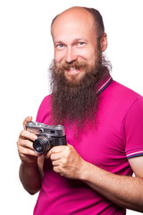 The portrait of bald bearded man photographer with pink t shirt holding classic camera. isolated on white background. studio shot. 