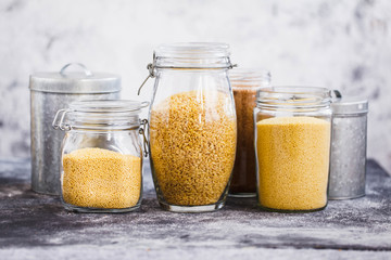 Quinoa, bulgur and couscous cereals glass jars.