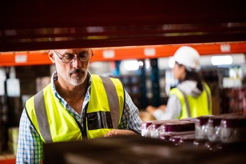 Workers warehouse tidying the shelves 