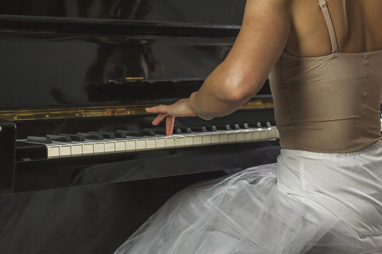 Close up ballerina hand playing the piano