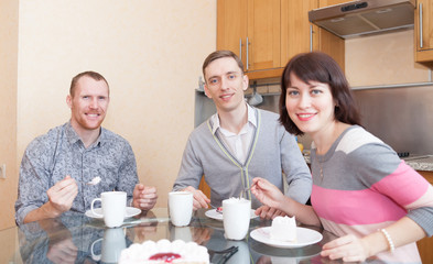 company of friends   in   kitchen and drinking tea.