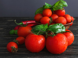 Tomatoes on vine, red chilli and green basil