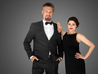 Happy mature couple on dark background